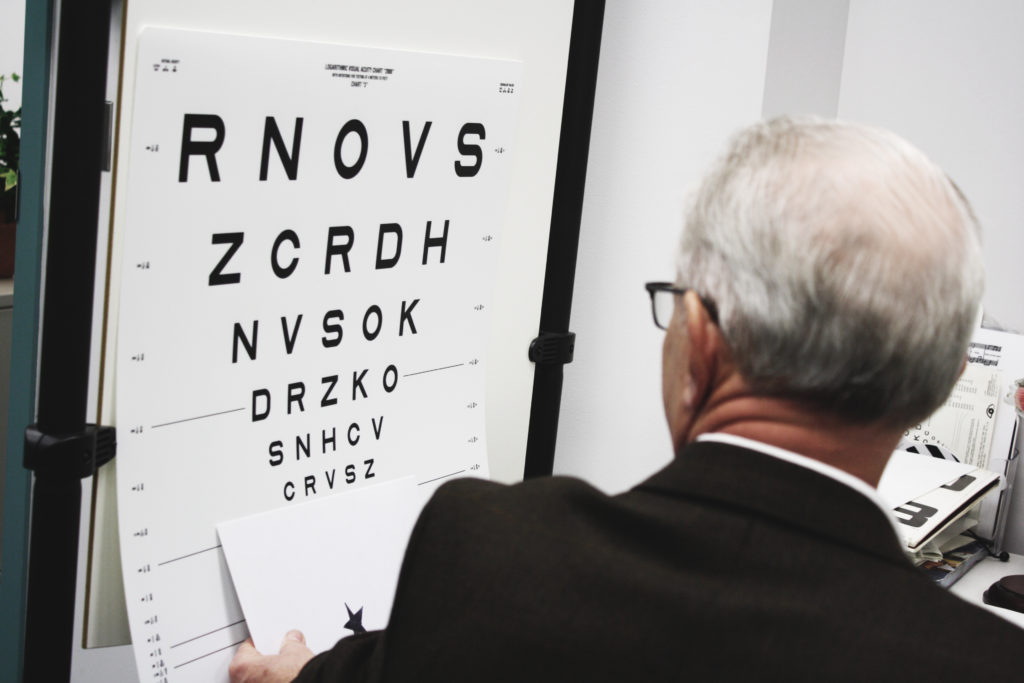 a low vision doctor showing the low vision chart