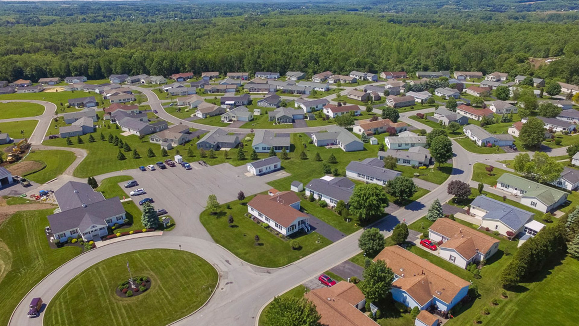 A bird's eye view of a housing development. There are over 50 houses in view